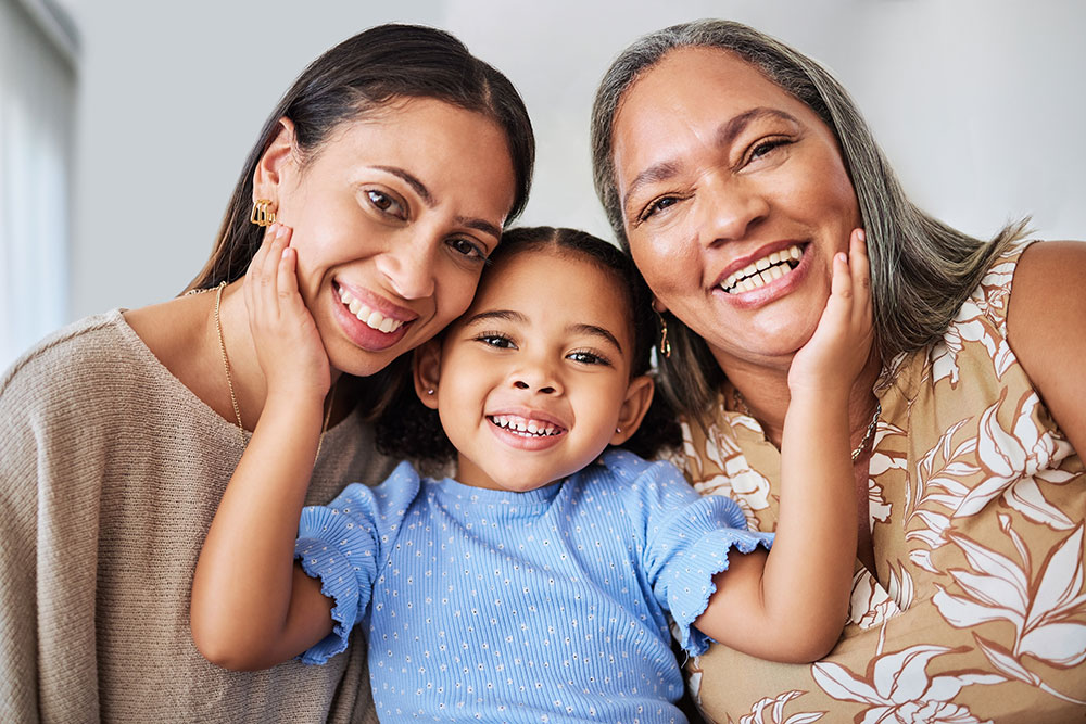 Smiling little girl, mother and grandmother.